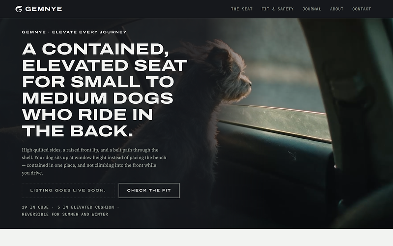 The Gemnye homepage hero: the headline for a contained, elevated seat for small to medium dogs who ride in the back, a Listing goes live soon notice beside a Check the fit button, over a dark film frame of a small dog looking out of a car window